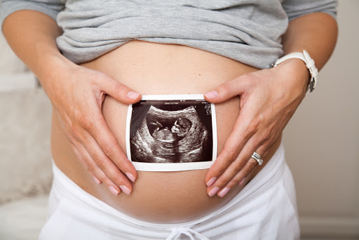A pregnant woman holding ultrasound scan &#8211; fr