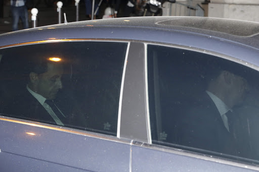 Former French President Nicolas Sarkozy (L) leaves the financial crimes section, on July 2, 2014 in Paris.