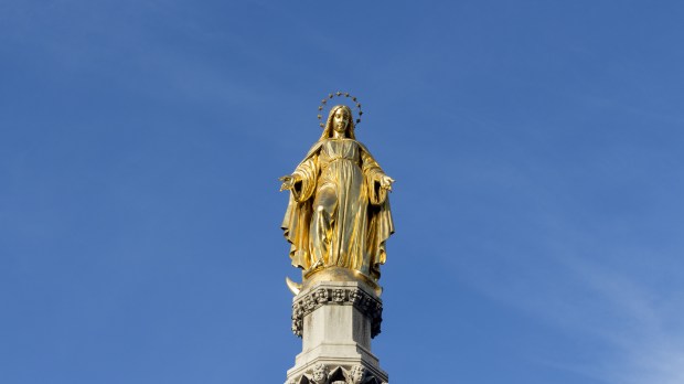 Golden statue of virgin Mary on column
