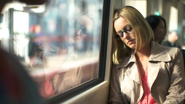 Businesswoman napping on train