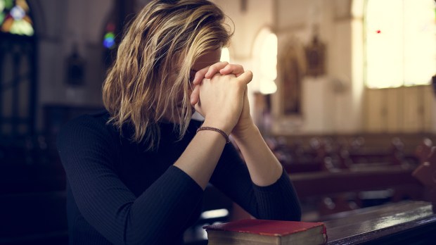 web-woman-praying-hands-church-face-covered-pew-rawpixel-shutterstock_516844036