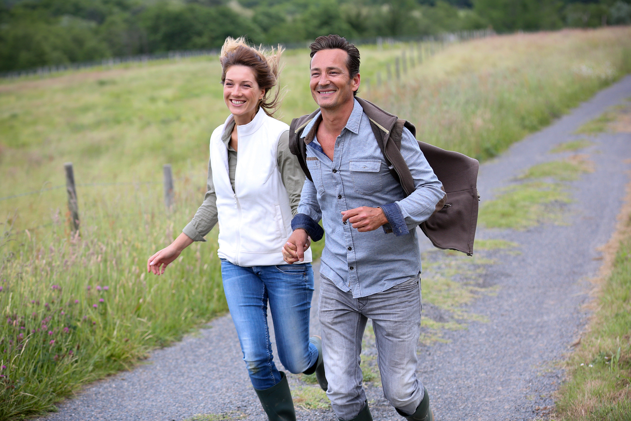 web-happy-middle-aged-couple-running-goodluz-shutterstock_196238294