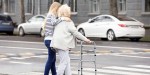 WOMAN HELPING ELDERLY
