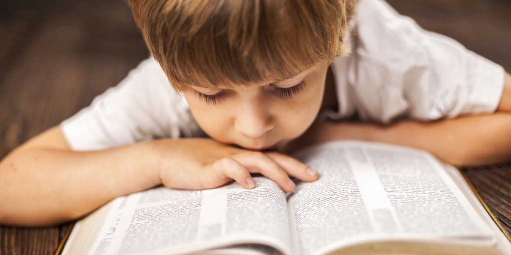 LITTLE BOY READING BIBLE
