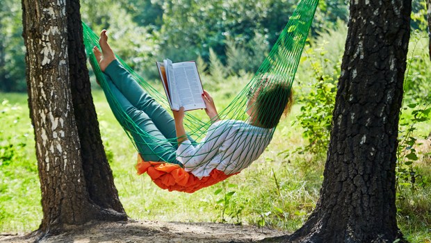 WOMAN READS BOOK