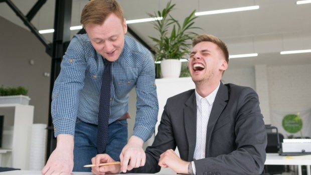 MEN LAUGHING WORK Shutterstock