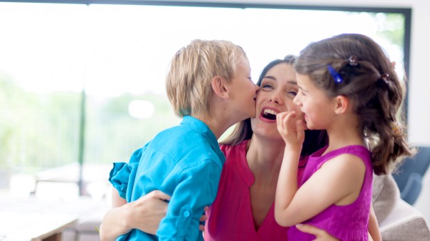 web3-kids-kissing-their-mother-on-a-couch-shutterstock_213498142.jpg