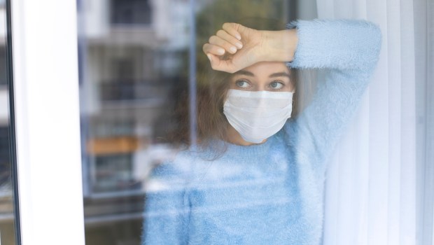 femme à la fenêtre avec un masque