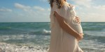 Happy Young Pregnant Woman on the Beach at the Atlantic Ocean
