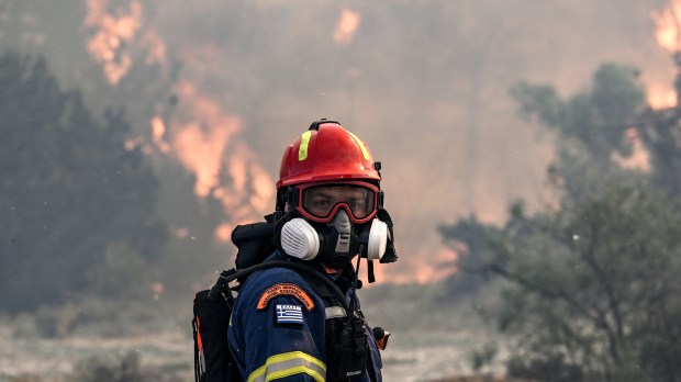A firefighter looks on during a fire near the village of Vati, just north of the coastal town of Gennadi, in the southern part of the Greek island of Rhodes on July 25, 2023.