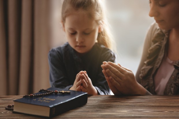 Girl praying rosary