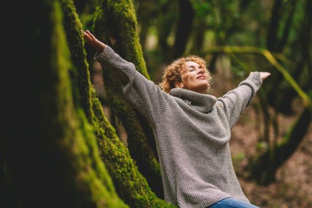 happy woman enjoying the green beautiful nature