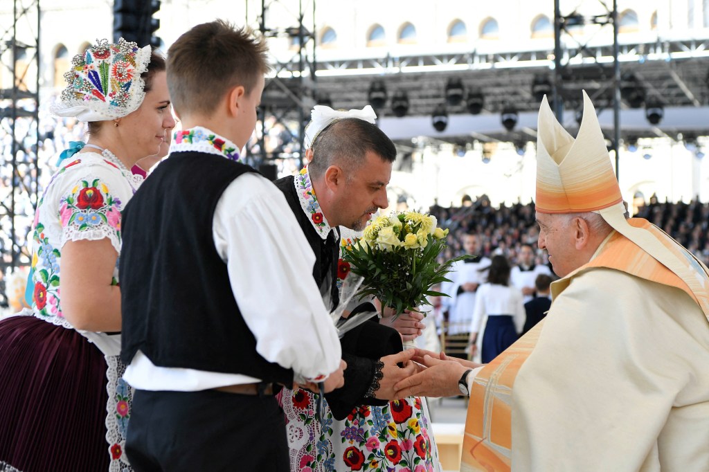 Pope-Francis-is-greeted-by-believers-wearing-traditional-Hungarian-dresses-as-he-celebrates-a-holy-mass-at-Kossuth-Lajos-Square-during-his-visit-in-Budapest