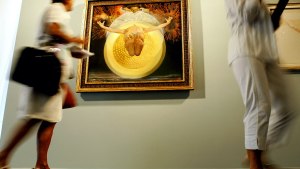 Visitors pass in front of a Salvador Dali's oil on canvas painting "Ascension (Pieta)" during the vernissage of the Spanish artist's exhibition at Palazzo Grassi in Venice 09 September 2004.
