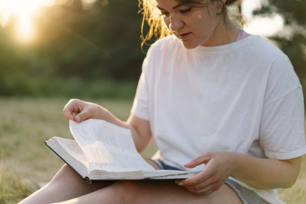 Christian woman holds bible in her hands