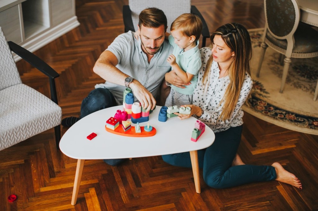 Mom and dad playing game with young child