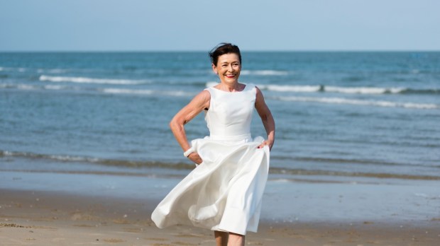 Woman on the beach with a white dress