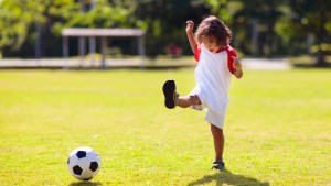 boy kicking soccer football