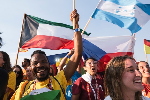Pilgrims pray during the World Youth Days vigil with young people in Tejo Park, Lisbon