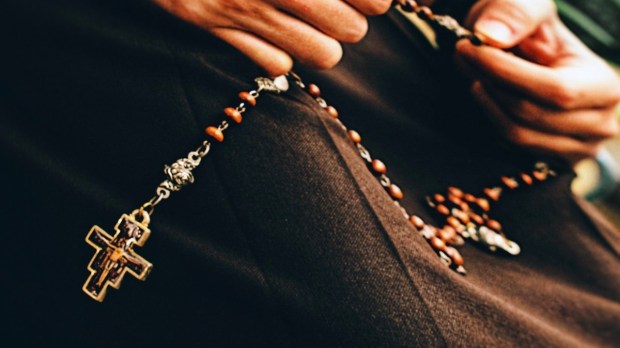 Woman praying rosary