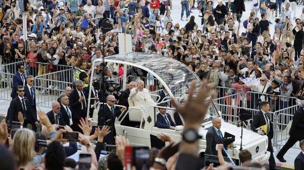 Pope Francis waves as he arrives in his popemobile to celebrate mass at the Velodrome stadium