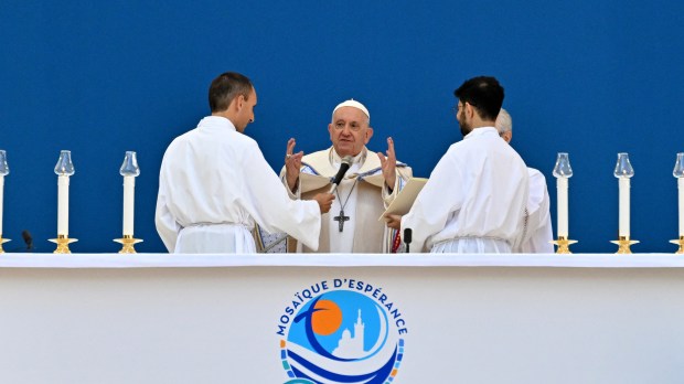 Pope Francis waves as he arrives to celebrate mass at the Velodrome stadium in the southern port city of Marseille