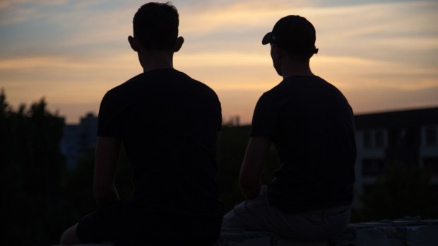 Young men talking outside